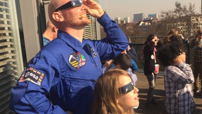 Cómo disfrutar del eclipse sin riesgos: la seguridad propia El astronauta de la ESA Alexander Gerst y un grupo de niñas y niños observan un eclipse solar en Berlín